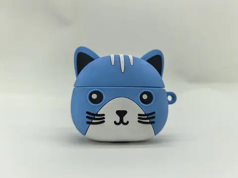 Blue silicone earbud case moulded as a cat head, with moulded ears, printed eyes and a lanyard loop.