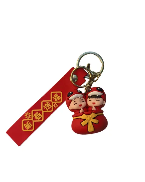 Two Chinese New Year figures on a red money bag charm, hung from a red strap with gold lattice print